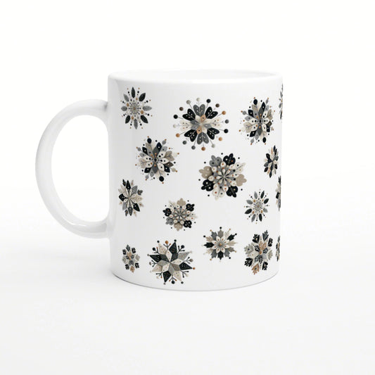 White ceramic mug featuring scattered black, beige and gray floral snowflake patterns; product mockup.