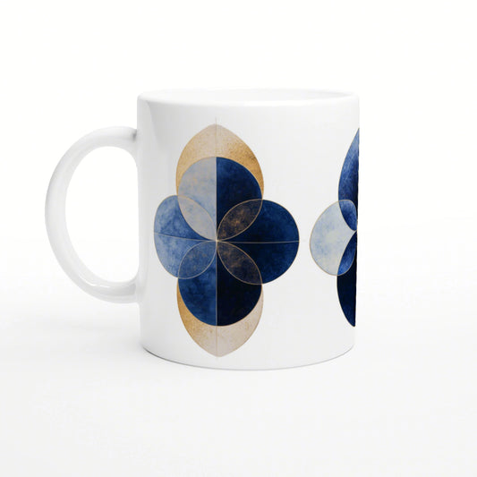 White ceramic mug with a geometric blue floral motif and gold outlines; four overlapping blue petals.