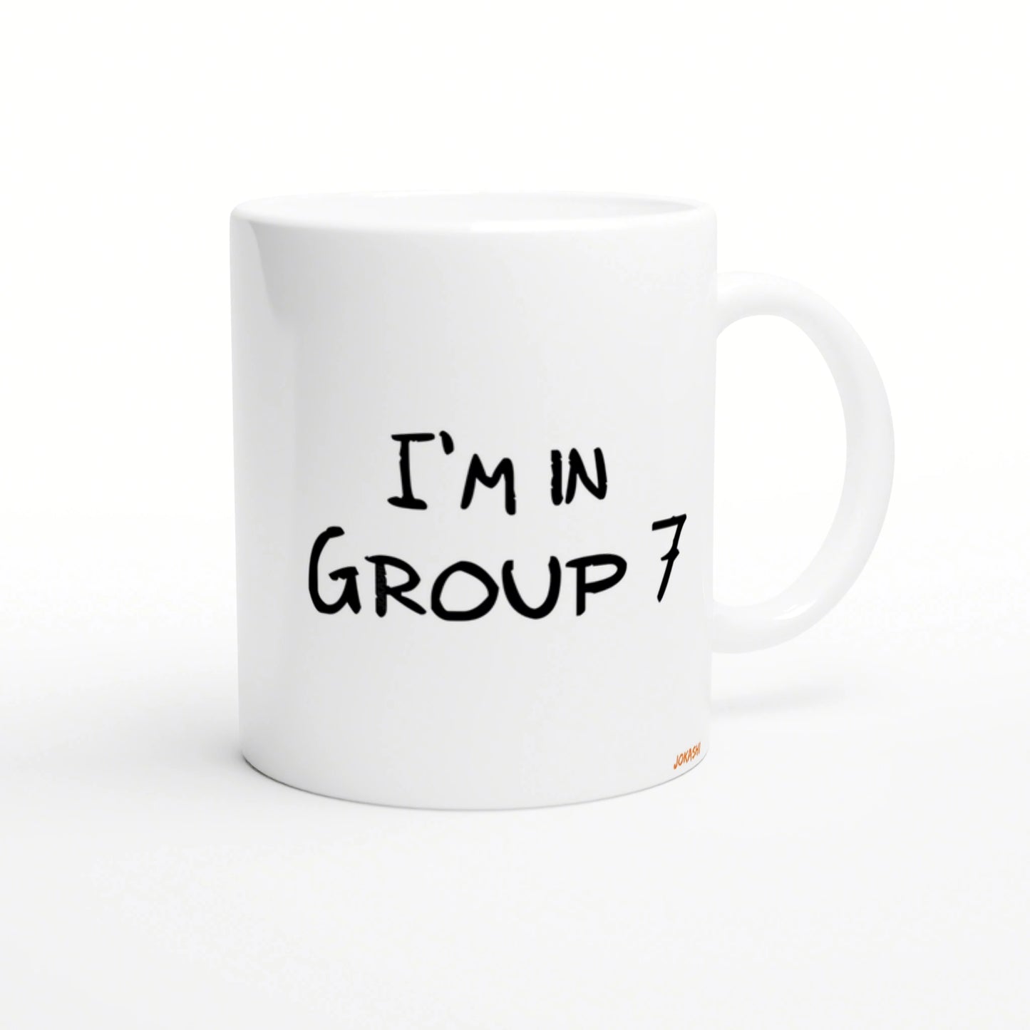 White ceramic mug mockup with black handwritten text 'I'M IN GROUP 7'.