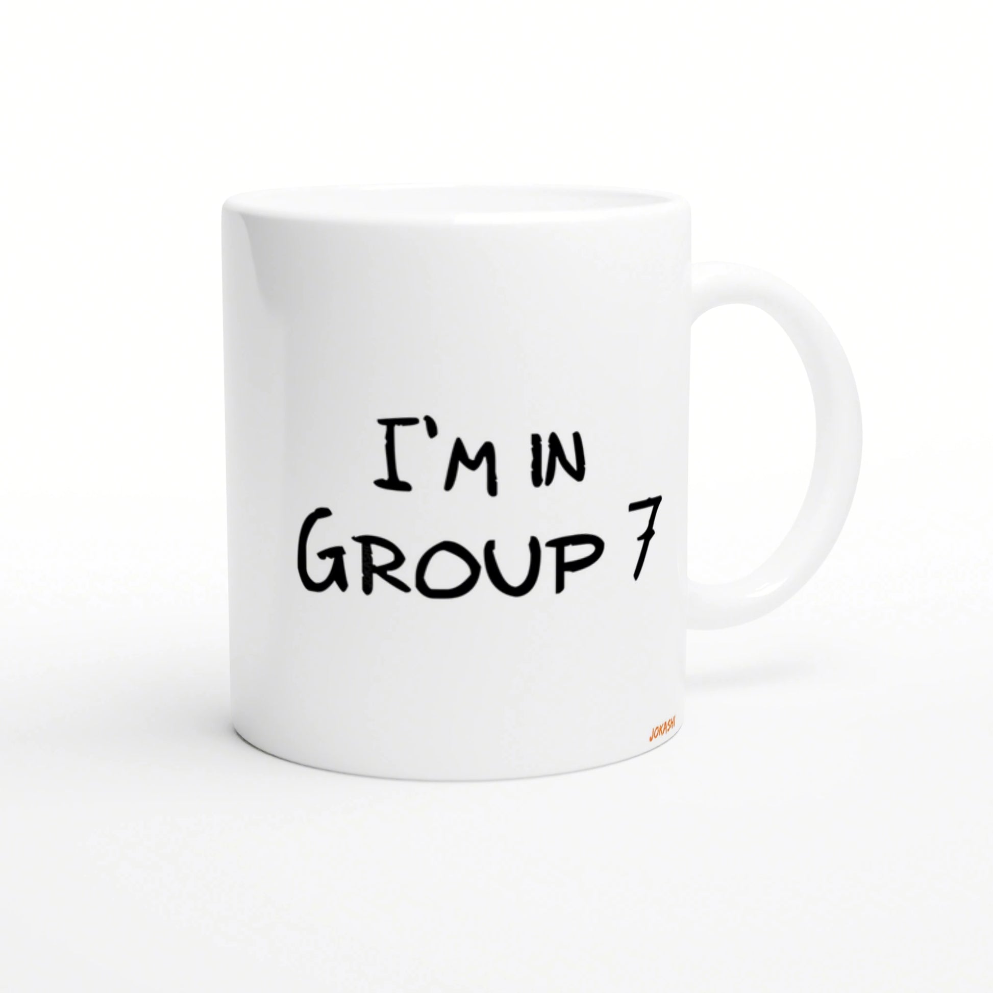 White ceramic mug mockup with black handwritten text 'I'M IN GROUP 7'.