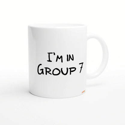White ceramic mug mockup with black handwritten text 'I'M IN GROUP 7'.