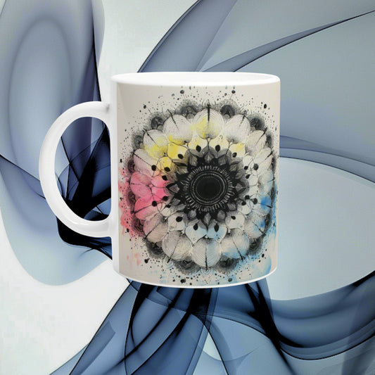 White ceramic mug featuring an intricate black-and-white mandala with pastel color splashes, set against a blue abstract background.