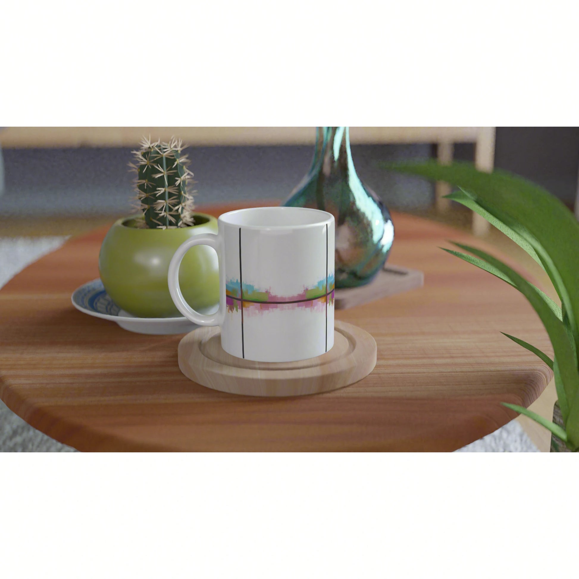 White ceramic mug mockup with abstract colorful stripe design on a wooden coaster, atop a wooden table with a plant and vase.