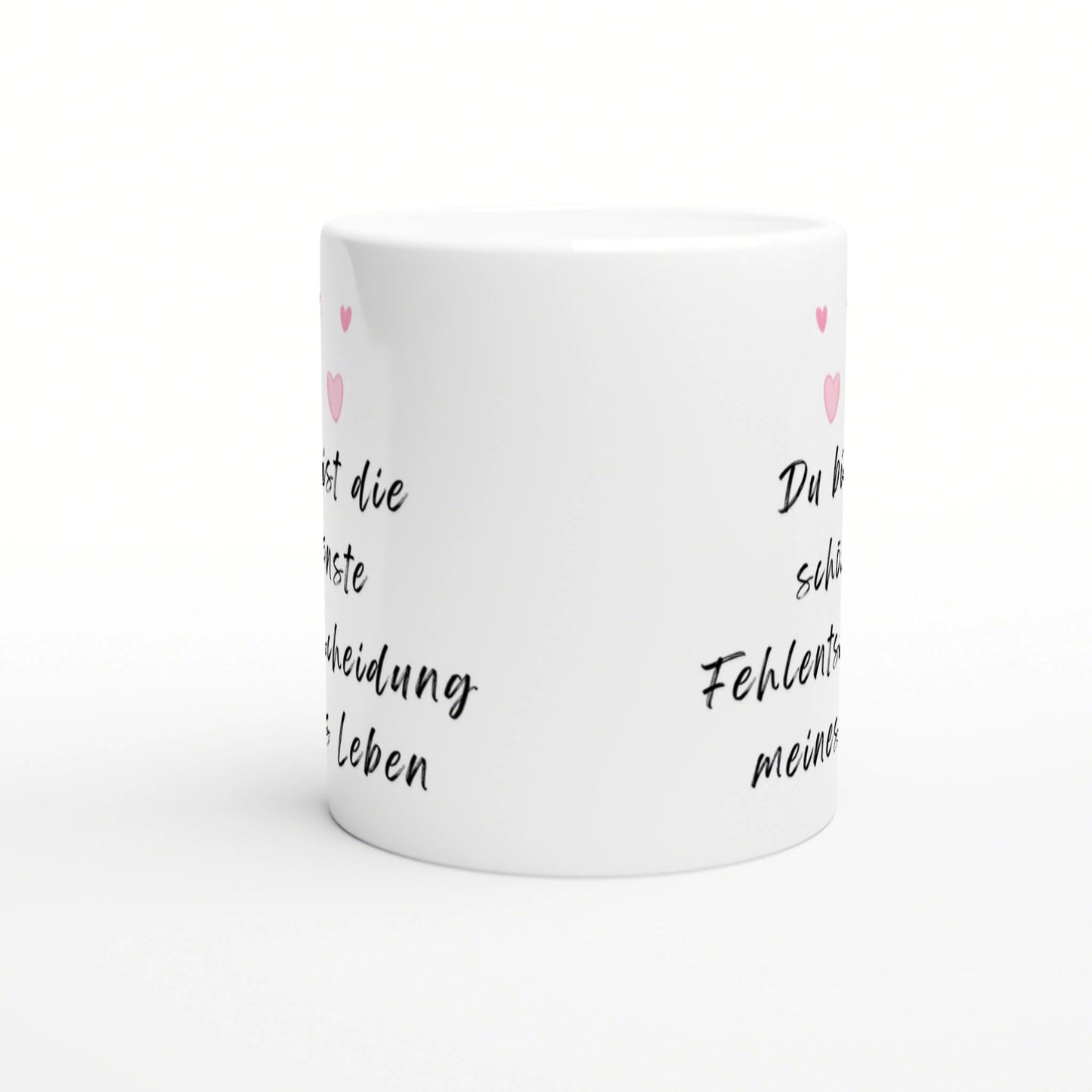 White ceramic mug mockup with black cursive German text and small pink hearts along the sides.
