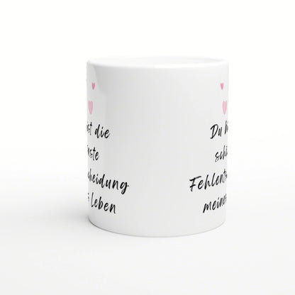 White ceramic mug mockup with black cursive German text and small pink hearts along the sides.
