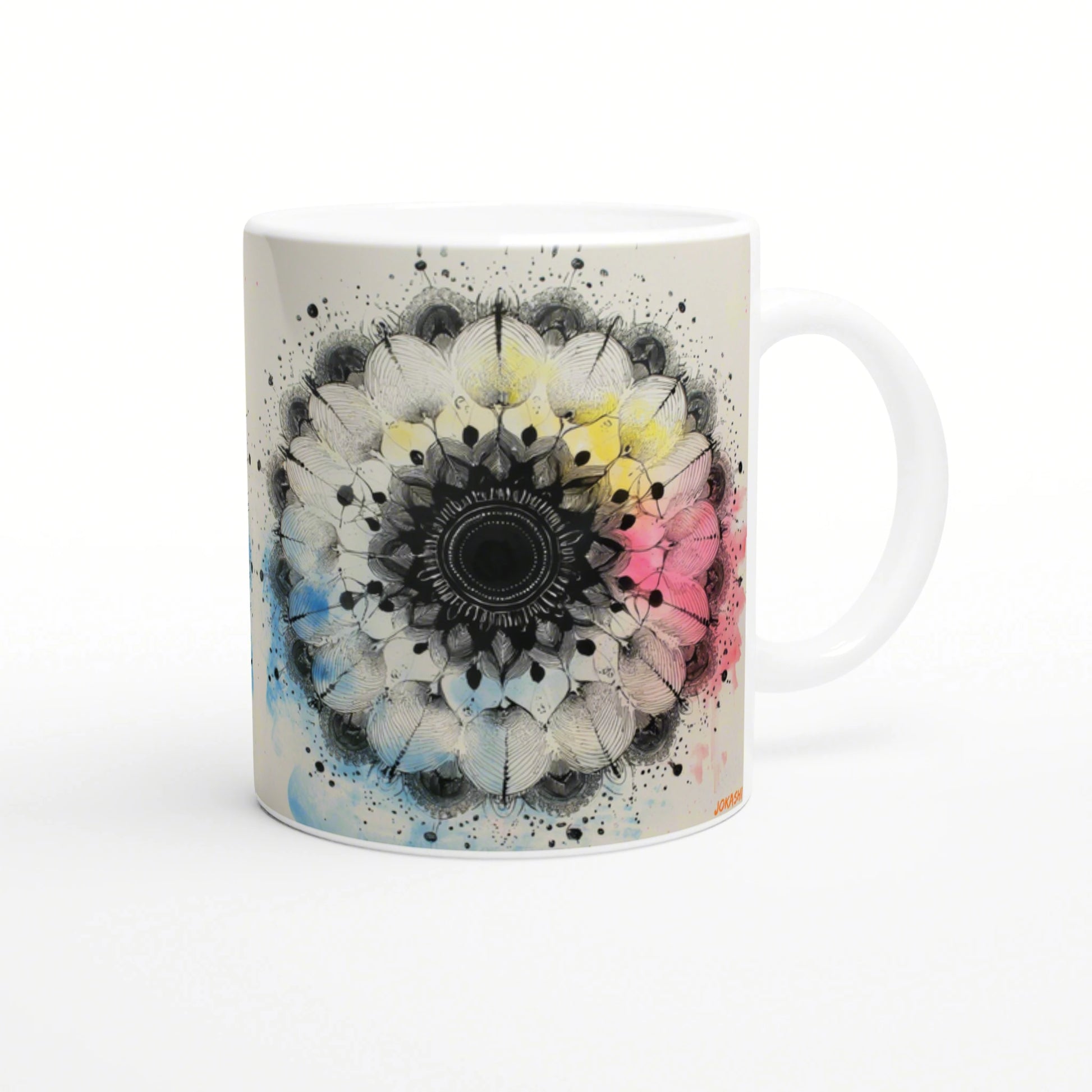White ceramic mug mockup with a black mandala at the center and pastel watercolor splashes in blue, pink, and yellow.