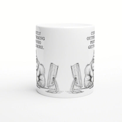 White ceramic mug mockup with a black-and-white sketch of two furry creatures beside angled monitors and partial side text.