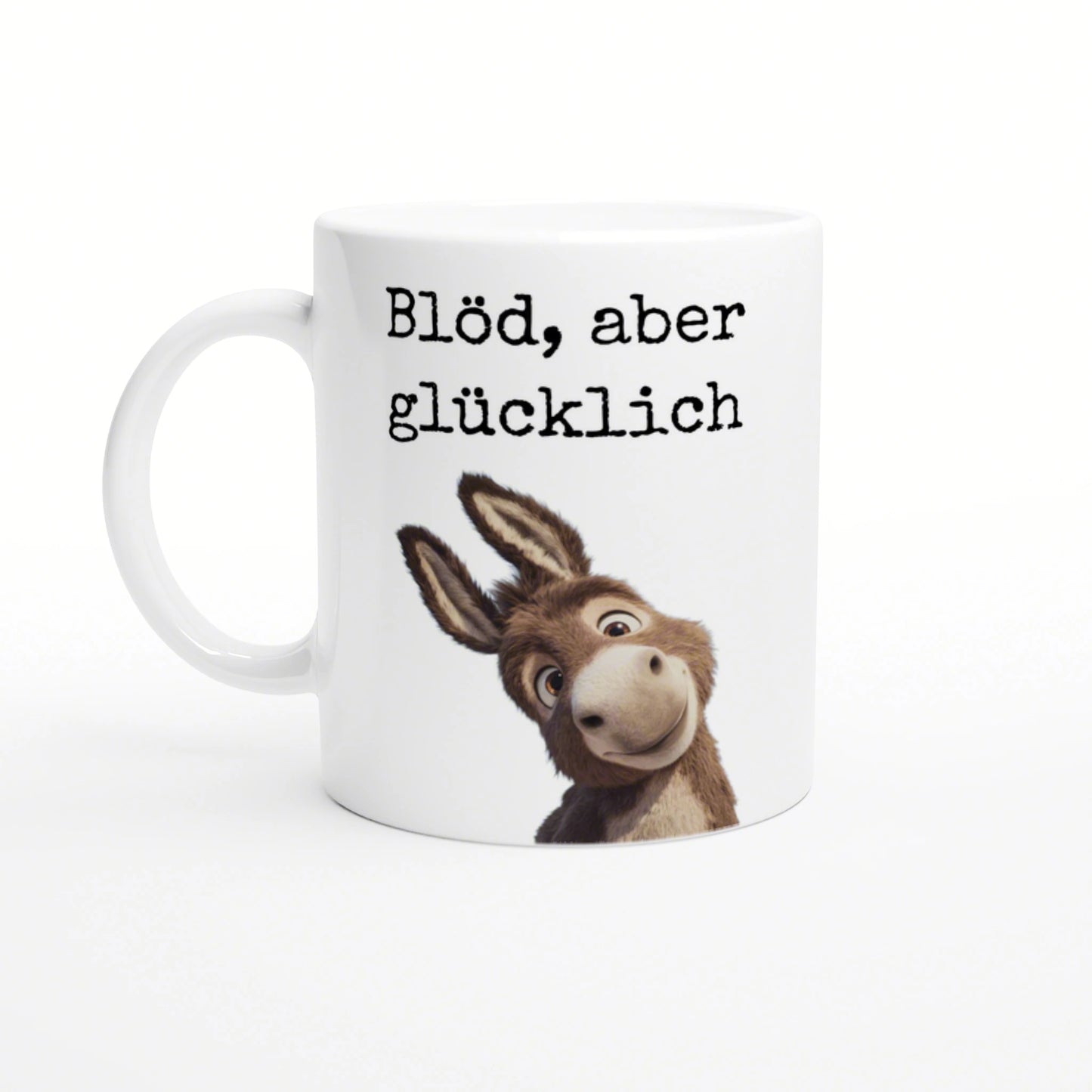 White ceramic mug mockup with black typewriter-style text Blöd, aber glücklich and a cartoon donkey peeking from the bottom.