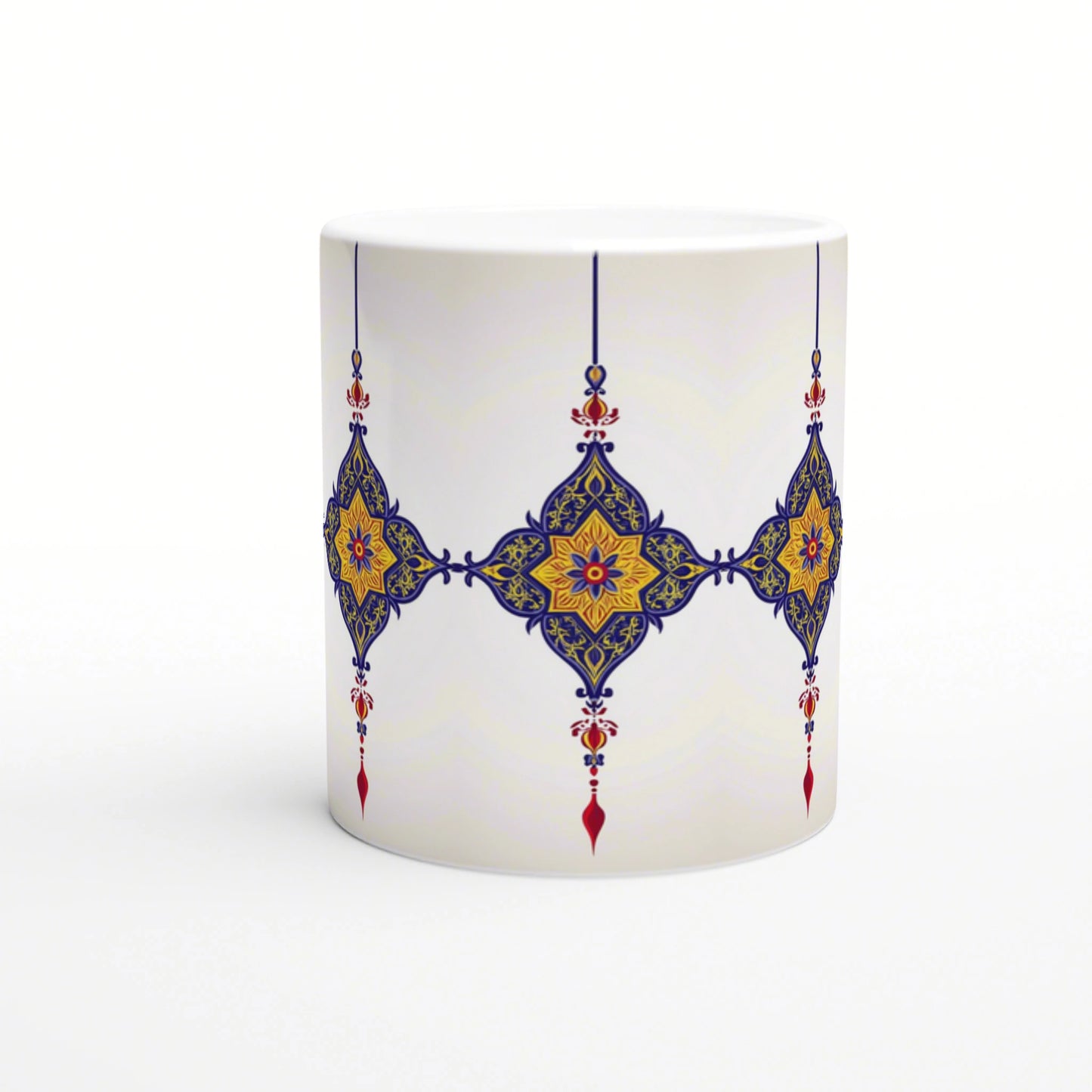 White ceramic mug mockup with repeating blue-and-gold ornate arabesque pattern and hanging pendant accents across the middle.