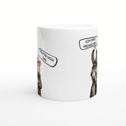 White ceramic mug mockup featuring cartoon animals with speech bubbles reading 'Mutig von dir.' and 'Ich mag Menschen.'