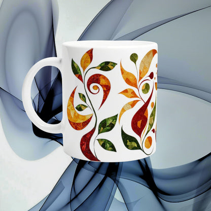 White ceramic mug mockup with a colorful abstract leaf pattern in orange, red and green on a blue abstract background.