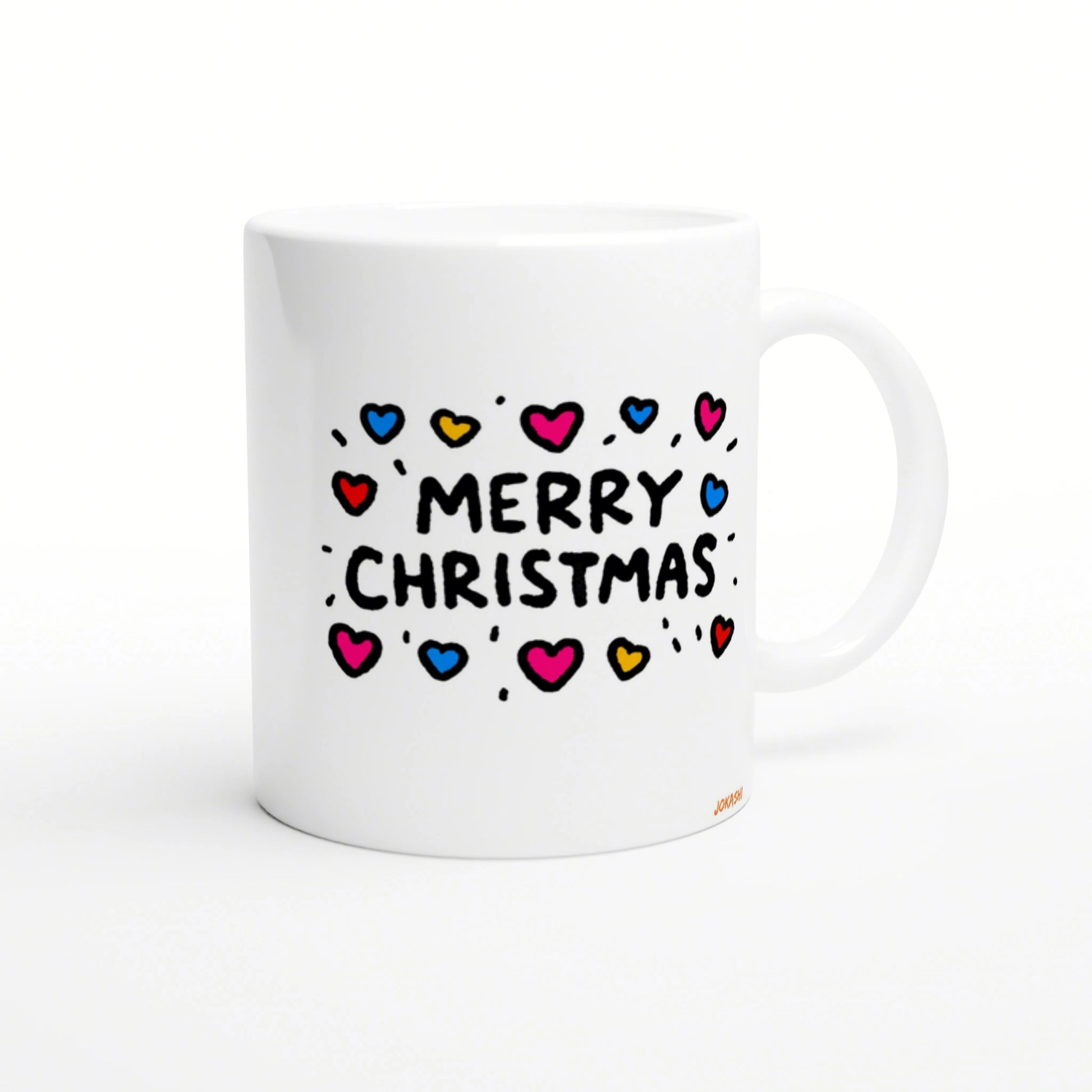White ceramic mug mockup featuring a hand-drawn 'MERRY CHRISTMAS' design with colorful hearts and doodle accents.