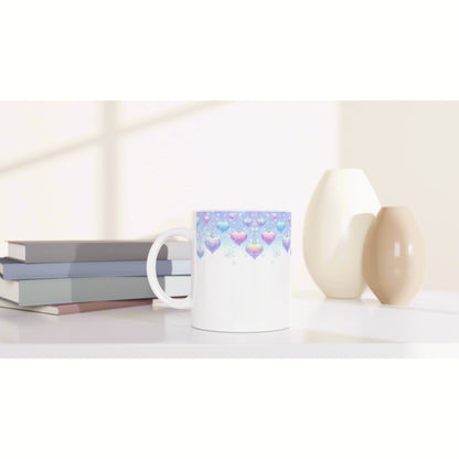 White ceramic mug mockup with a pastel blue gradient and heart pattern, placed on a shelf beside books and decorative vases.