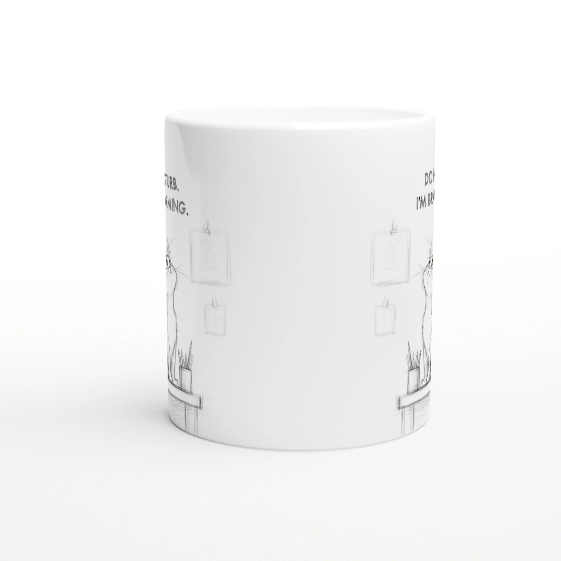 White ceramic mug mockup with a subtle pencil-sketch desk scene and small frames.