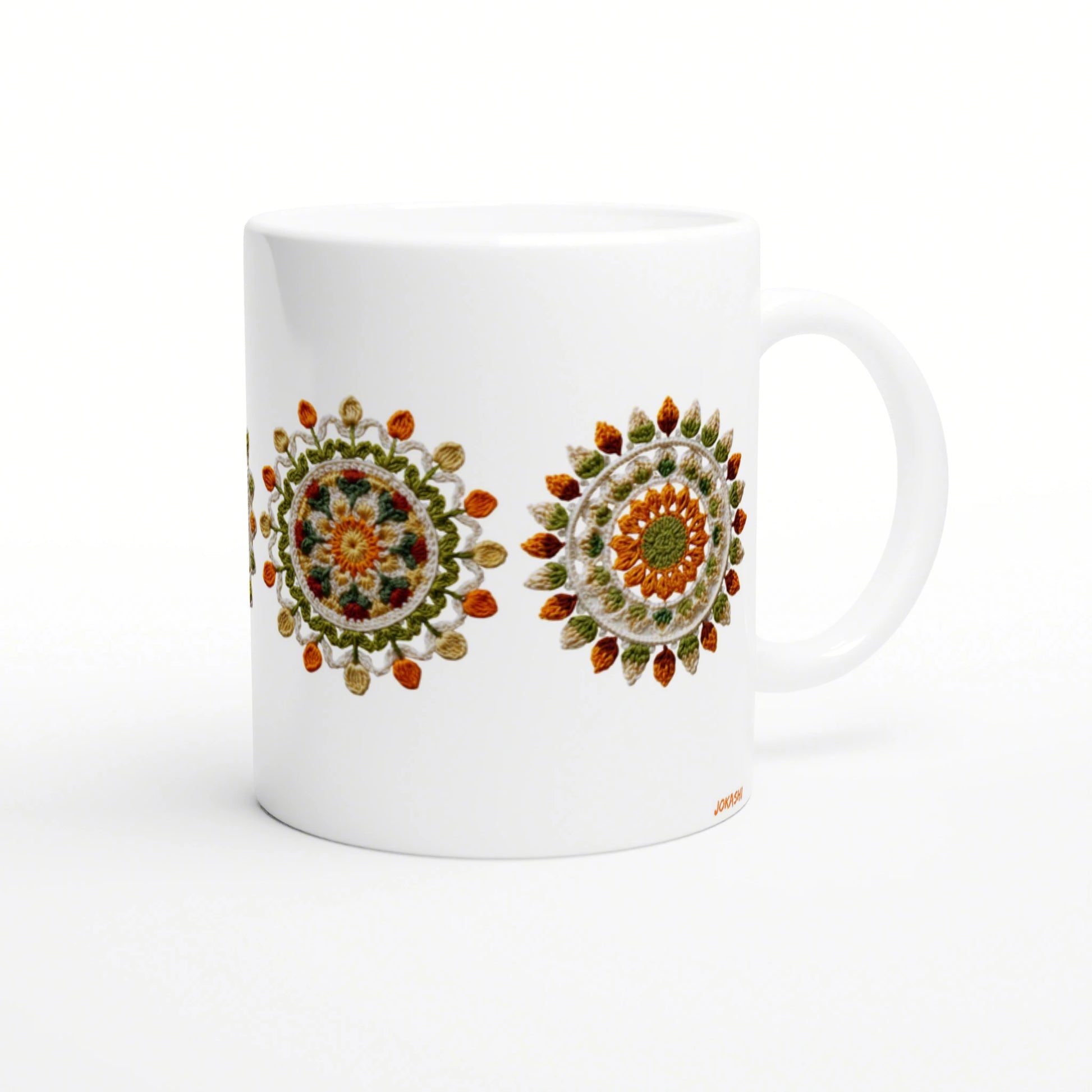 White ceramic mug mockup featuring two colorful crochet mandala designs in orange, green and yellow.