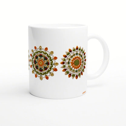 White ceramic mug mockup featuring two colorful crochet mandala designs in orange, green and yellow.