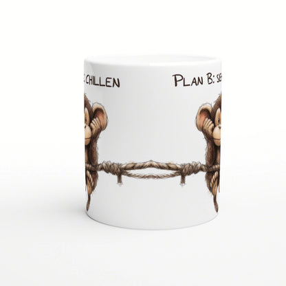 White ceramic mug mockup with two cartoon monkeys on either side holding a rope, partial slogan along the rim.