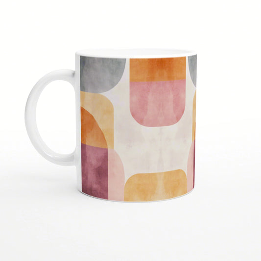 Product mockup of a white ceramic mug with pastel abstract geometric shapes in pink, orange, yellow and gray.