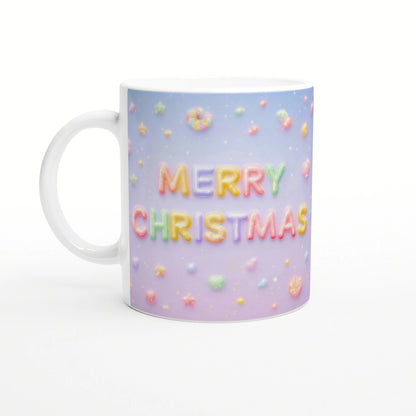 White ceramic mug with pastel gradient background and candy-like 'MERRY CHRISTMAS' lettering, surrounded by small colorful sweets.