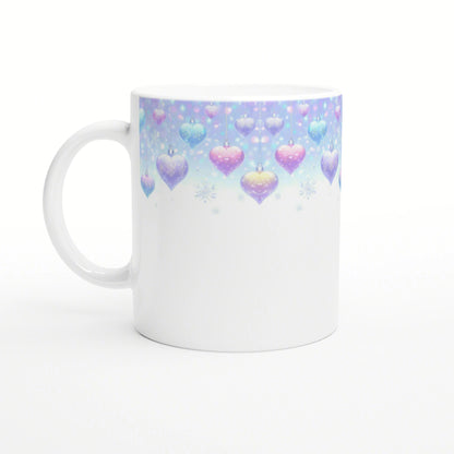 White ceramic mug with pastel gradient rim featuring hanging heart ornaments and snowflakes, white body.
