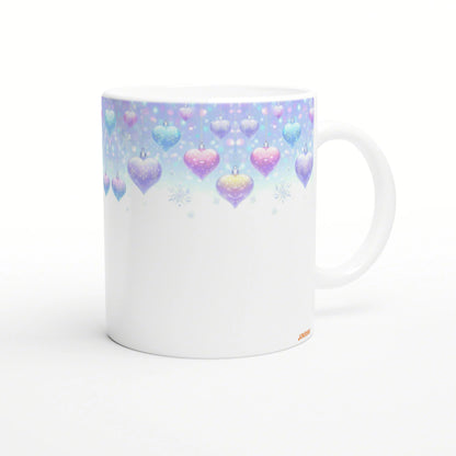 White ceramic mug mockup with pastel hanging hearts and snowflakes along a blue-to-pink gradient top.