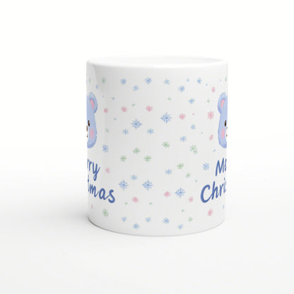White ceramic mug mockup with pastel snowflakes, a blue bear illustration, and blue 'Merry Christmas' text.