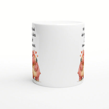 White ceramic mug mockup featuring a pink cartoon pig with hearts at the base and partial black slogan text along the sides.