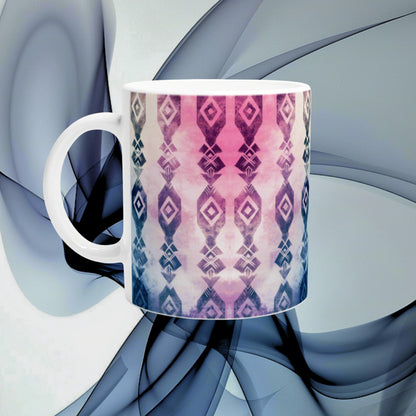 White ceramic mug with pink-to-blue geometric diamond pattern, shown as a product mockup against an abstract blue backdrop.