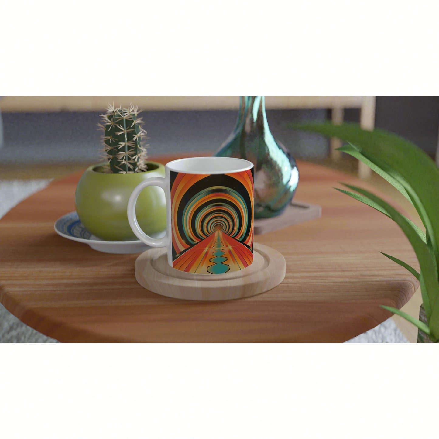 White ceramic mug featuring a vivid psychedelic tunnel pattern on a wooden table, beside a green cactus pot and a teal vase.
