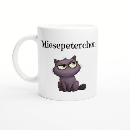 White ceramic mug featuring a purple grumpy kitten and the text Miesepeterchen in black above it.