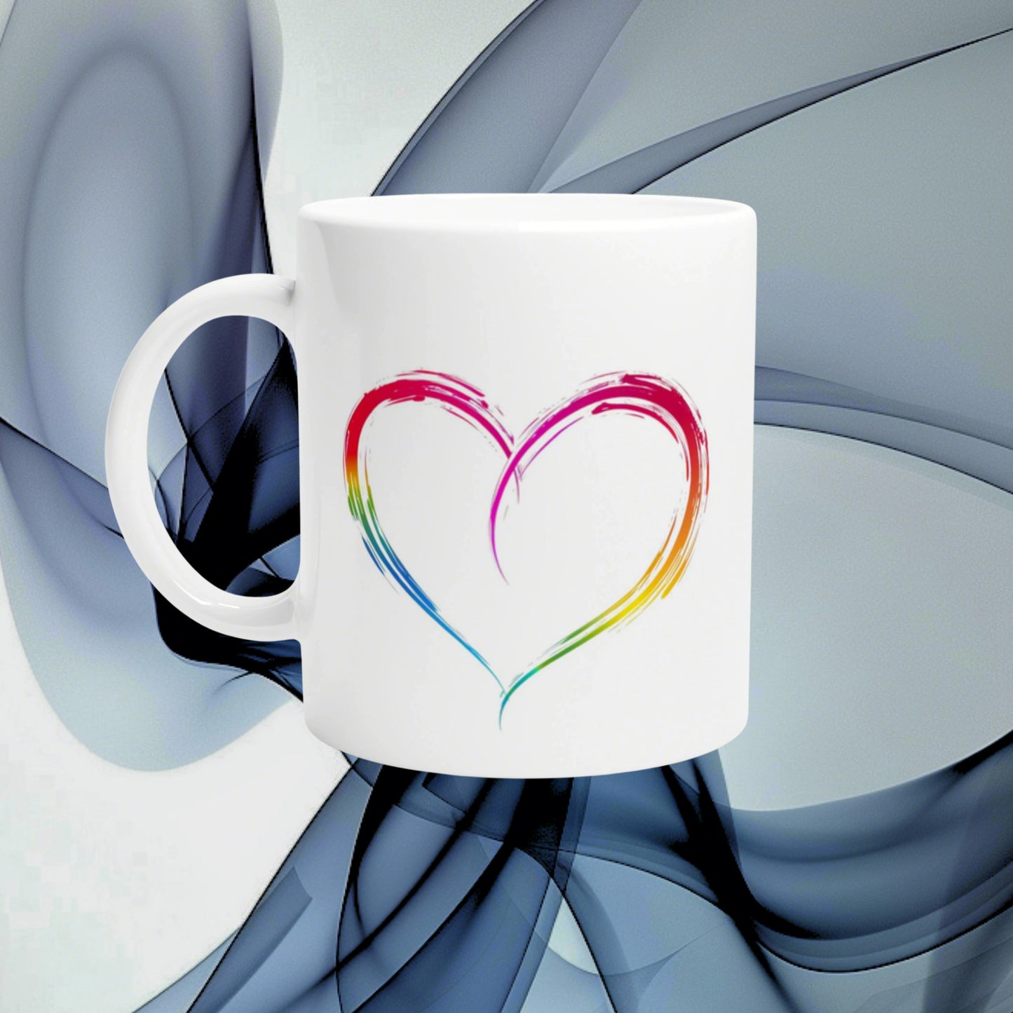 White ceramic mug featuring a rainbow heart brushstroke print, shown as a product mockup against an abstract blue background.