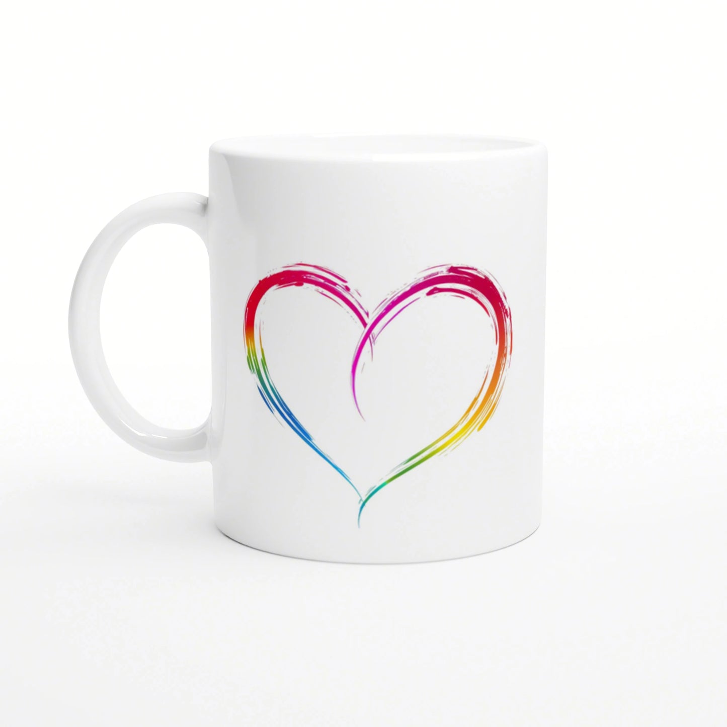 White ceramic mug with a rainbow brushstroke heart design, presented as a product mockup.
