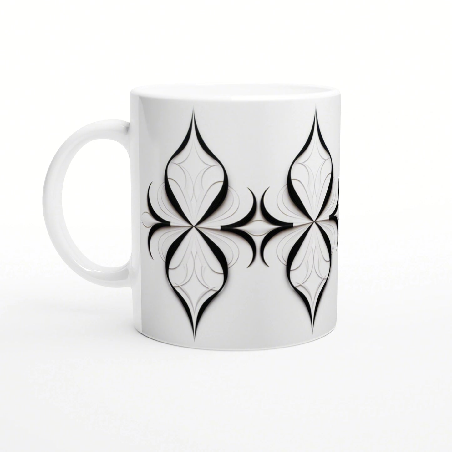 White ceramic mug featuring a repeating black geometric quatrefoil motif; product design mockup.