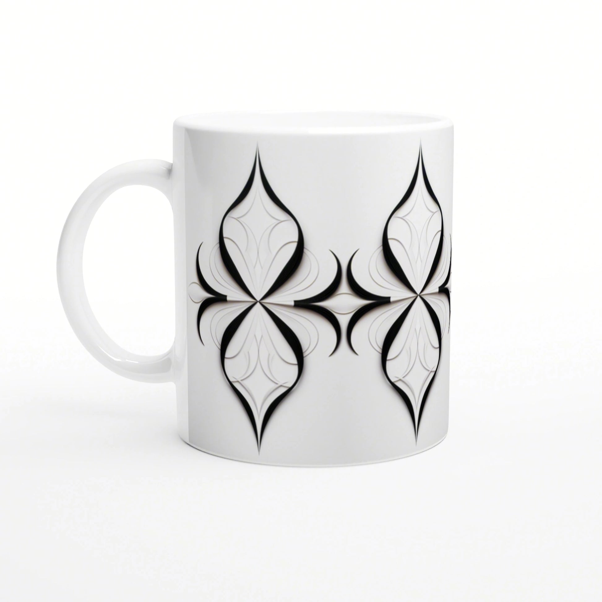 White ceramic mug featuring a repeating black geometric quatrefoil motif; product design mockup.