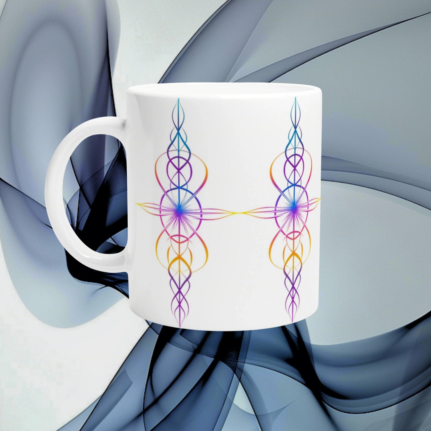 White ceramic mug featuring symmetrical rainbow-colored ornamental line patterns forming a cross-like design.