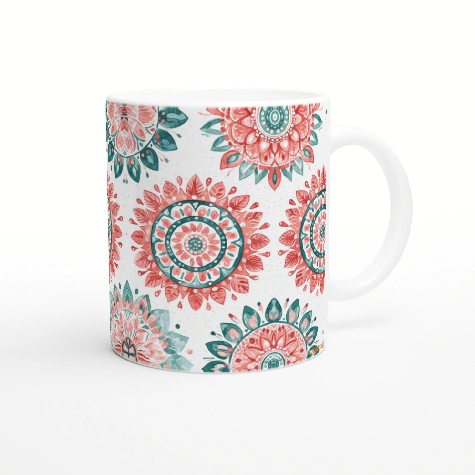 White ceramic mug featuring teal and coral mandala patterns; product mockup for a shop selling mugs and t-shirts.