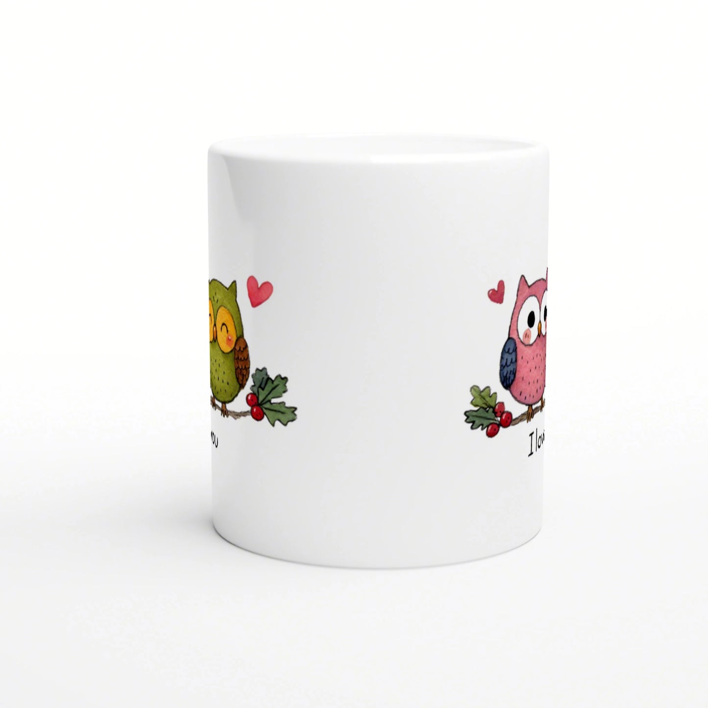 White ceramic mug featuring two cartoon owls with hearts and holly on the sides; playful product mockup.