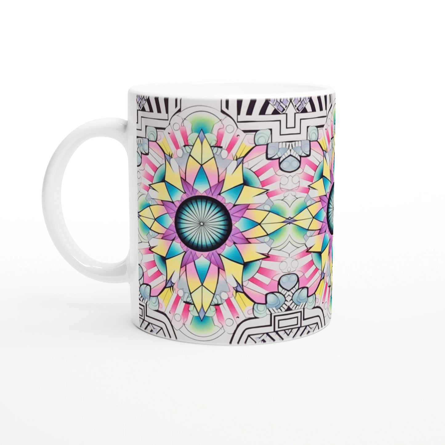 White ceramic mug with a vibrant multi-colored mandala design in teal, pink and yellow; black geometric border.