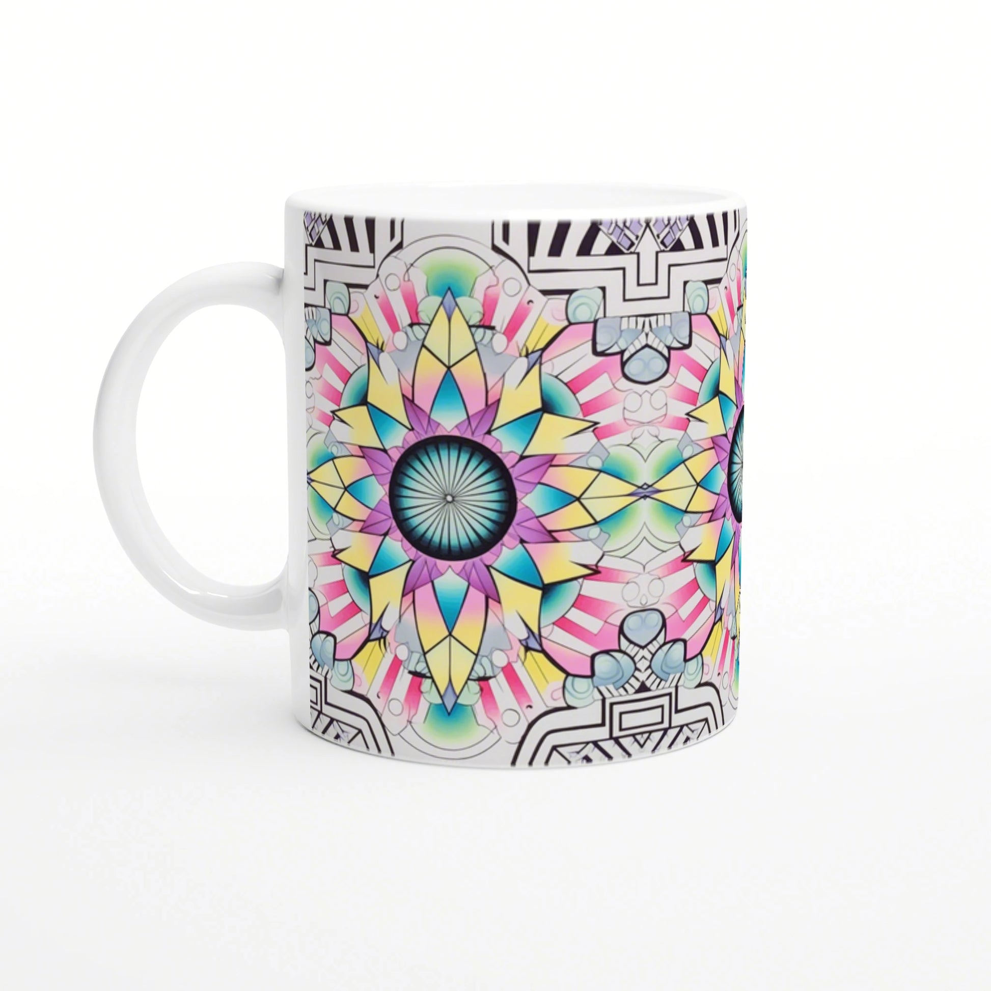 White ceramic mug with a vibrant multi-colored mandala design in teal, pink and yellow; black geometric border.