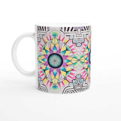 White ceramic mug with a vibrant multi-colored mandala design in teal, pink and yellow; black geometric border.