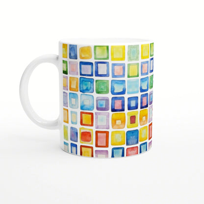 White ceramic mug featuring a vibrant watercolor grid of multicolored squares.