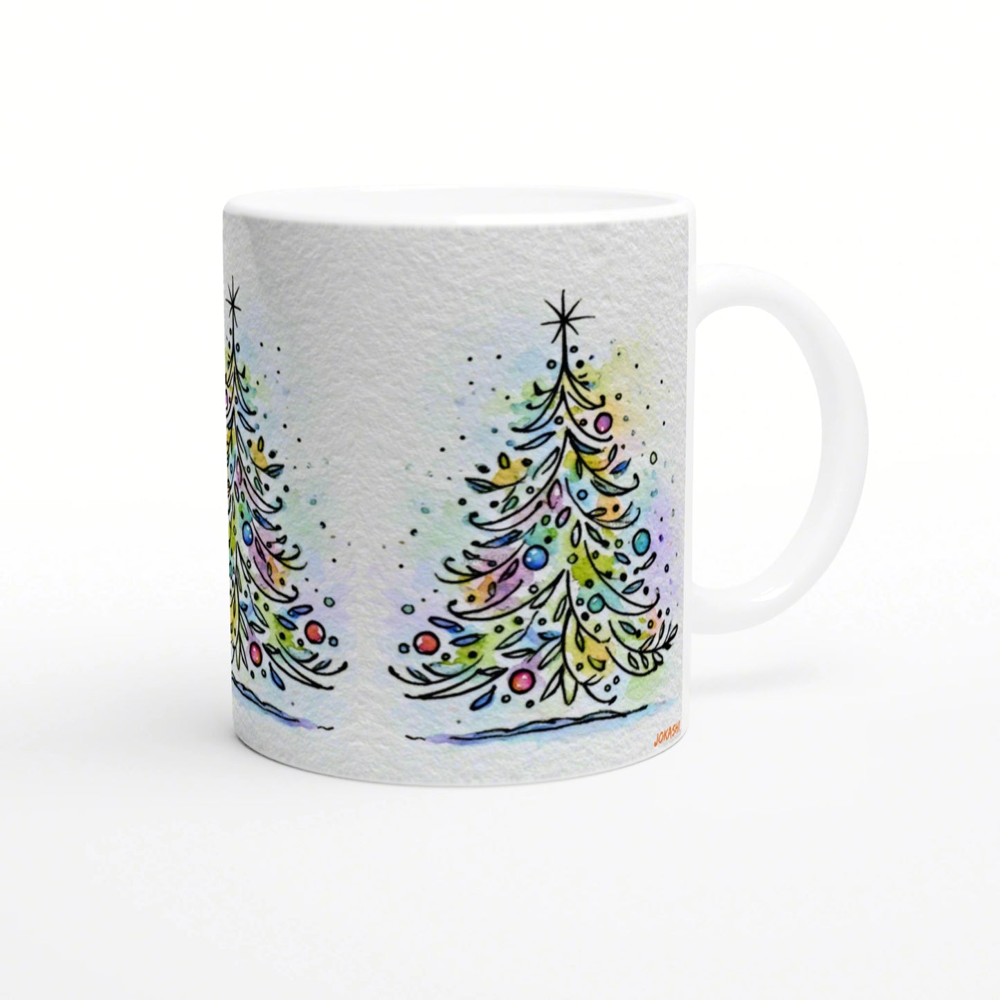 White ceramic mug featuring a watercolor Christmas tree design with colorful ornaments and snowy specks.