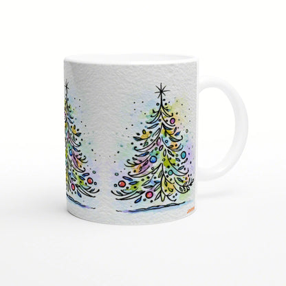 White ceramic mug featuring a watercolor Christmas tree design with colorful ornaments and snowy specks.