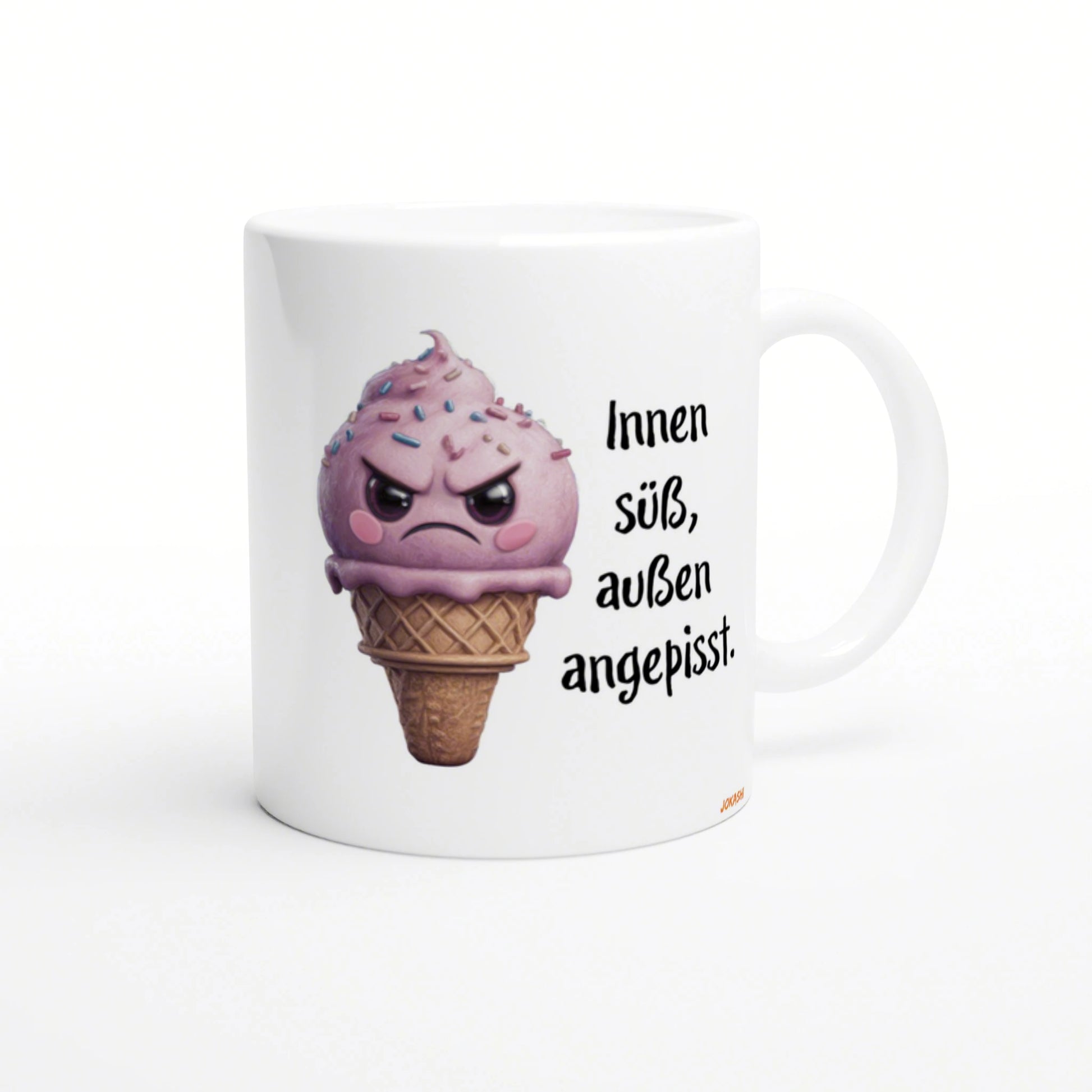 White mug featuring a pink, angry ice-cream cone with sprinkles, alongside the German text Innen süß, außen angepisst.