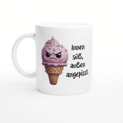 White mug featuring a pink, angry ice-cream cone with sprinkles and the German caption 'Innen süß, außen angepisst'.