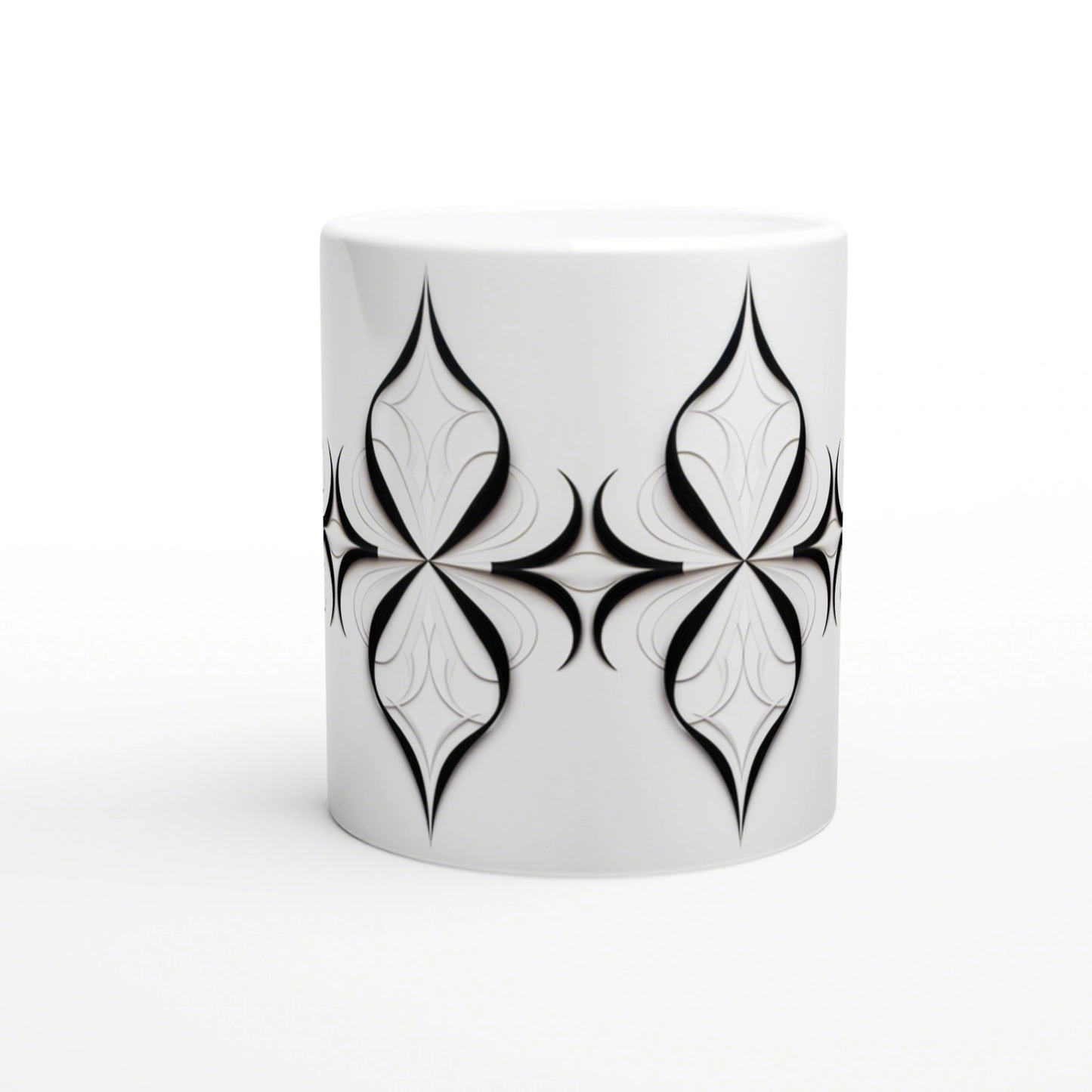 White ceramic mug mockup with a wraparound black ornamental geometric pattern of symmetrical teardrop motifs.