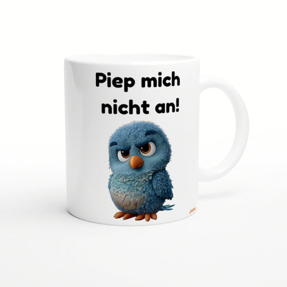White ceramic mug mockup featuring a blue fluffy cartoon chick and bold German text 'Piep mich nicht an!'