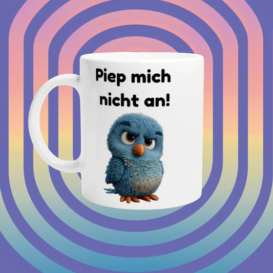 White mug featuring a blue fluffy chick and the German slogan 'Piep mich nicht an!' against a rainbow-patterned mockup background.
