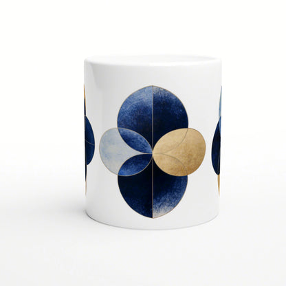 White mug featuring a blue and gold geometric flower motif made from overlapping circular petals; product mockup.
