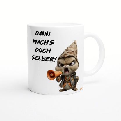 White mug featuring a grumpy hooded cartoon character shouting into a megaphone and the German text Dann mach's doch selber!